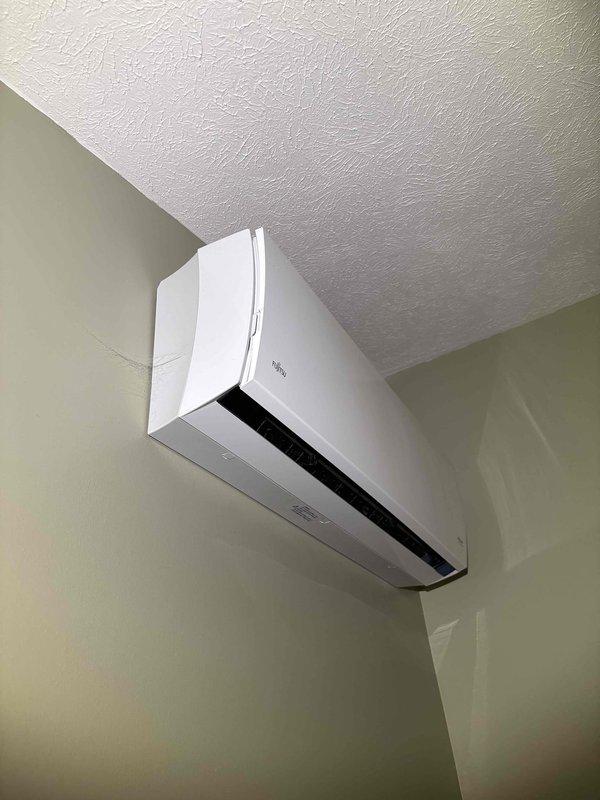 Responded to service call for 2011 Fujitsu ductless mini-split system with motorized vane slider malfunction. Upon arrival, confirmed unit was providing heating and cooling normally with no operational issues, error codes, or unusual noises. Removed front cover and inspected internal swing louver assembly and actuator motor mechanism. Found swing motor assembly binding due to mechanical obstruction in linkage arm. Cleared obstruction, lubricated pivot points on swing mechanism, and tested full range of motion. Cycled louver through all positions to verify proper operation. Reinstalled housing cover and confirmed vane movement responds correctly to remote control commands. Unit operating as designed with restored airflow direction control.