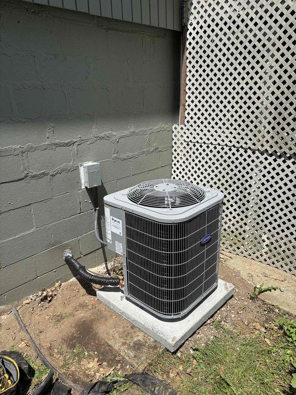 Completed full HVAC system installation including new furnace and air conditioning condenser unit. Installed furnace in basement with proper venting, refrigerant line connections, and secure mounting. Positioned outdoor AC condenser unit on concrete pad against exterior wall with appropriate clearances, connected electrical conduit, and completed all refrigerant piping connections between indoor and outdoor components.