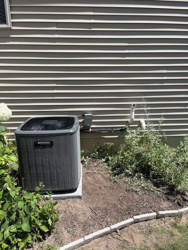 Completed full installation of residential HVAC system including furnace unit and air conditioning condenser. Installed dark gray furnace in mechanical room with proper venting using white PVC piping routed through utility space. Mounted outdoor AC condenser unit on concrete pad in landscaped area with appropriate refrigerant line connections and drainage piping along exterior wall. All equipment installed per manufacturer specifications with proper electrical connections, ductwork integration, and code-compliant venting. System tested and verified operational.