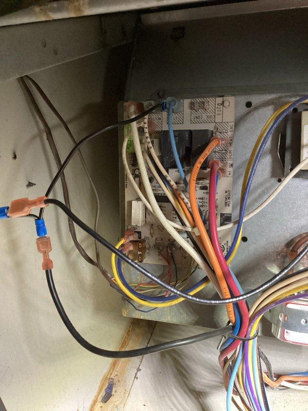 # No Cool Service Call - Outdoor AC Unit

Responded to no cooling complaint on residential air conditioning system. Upon arrival, found outdoor condenser unit with heavily soiled condenser coils showing significant dirt, dust, and debris accumulation restricting airflow. Unit appears to be 10+ years old based on condition and wear patterns.

Performed visual inspection of outdoor unit which revealed substantial contamination on protective coil grille requiring cleaning for proper heat exchange. Refrigerant lines and electrical conduits secured at top of unit with cable ties appeared intact. Unit nameplate indicates model number 2113E24483.

Accessed indoor air handler to inspect electrical controls and wiring connections. Found control board with multiple wire terminations in somewhat disorganized condition. Inspected all wire connections including blue, brown, black, yellow, orange, pink, white, gray, and tan conductors for proper termination and signs of overheating or failure. Contr