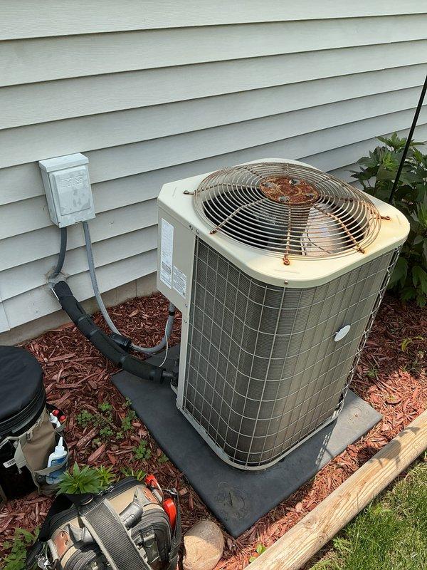 # No Cool Service Call

Responded to a no cooling complaint on a 4-year-old residential air conditioning system. Customer reported the outdoor fan running but no cool air being delivered throughout the home. Upon arrival, performed visual inspection of the outdoor condenser unit, which showed signs of weathering and corrosion on the fan guard and top surface. Documented equipment condition with photographs for service records. System evaluation completed to diagnose the cooling failure and determine necessary repairs to restore proper operation.