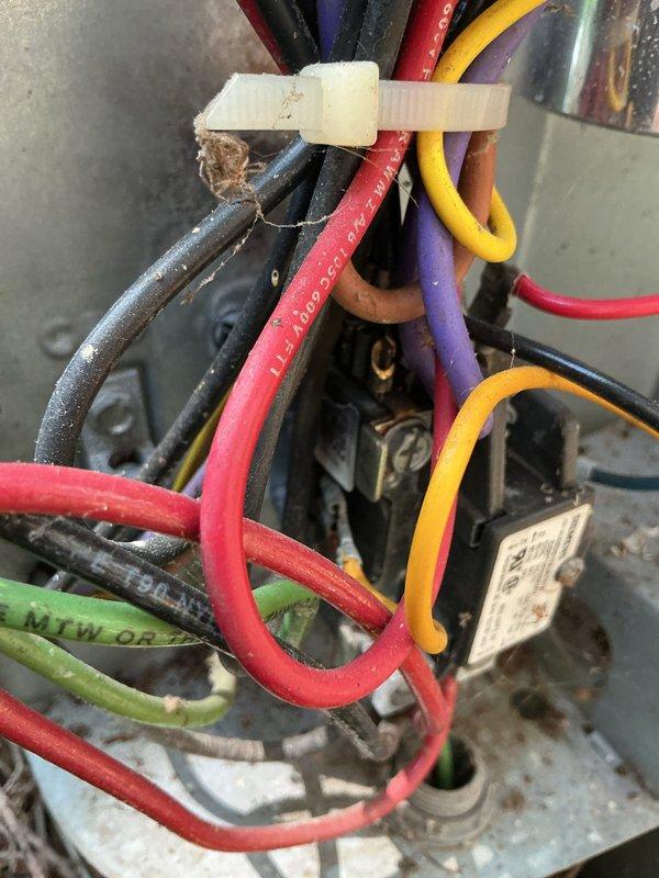 Responded to no cooling complaint on main floor air conditioning system. Upon arrival, inspected 14-18 year old Goodman unit and found electrical connection issues at the outdoor unit. Examined contactor, wiring connections, and electrical components within the condenser panel. Wiring showed signs of age with dust accumulation and environmental wear. Secured loose wire connections, cleaned electrical contacts, and verified proper voltage at contactor. Tested system operation and confirmed unit returned to normal cooling function.