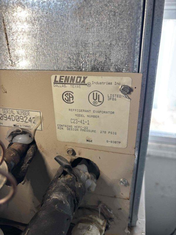 Responded to no cooling complaint on 23-year-old Lennox system with inadequate upstairs cooling while downstairs remained comfortable. Upon inspection, located Lennox refrigerant evaporator (Model C23-41-1) utilizing HCFC-22 refrigerant with heavy condensation present on equipment surfaces, indicating active refrigeration cycle. Performed diagnostic testing of electrical components using digital multimeter to verify capacitor functionality and system electrical integrity. All readings confirmed proper capacitor operation and electrical performance within manufacturer specifications. System age and differential cooling between floors suggests potential airflow imbalance, ductwork issues, or zoning concerns requiring further evaluation. Equipment operational at time of service.