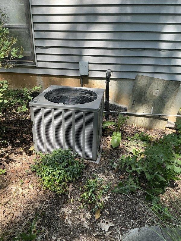 Conducted comprehensive evaluation of 15-year-old HVAC system experiencing inadequate cooling performance and insufficient airflow to remote areas of the home. Assessed outdoor condensing unit condition, noting vegetation growth and environmental factors affecting equipment performance, and inspected indoor furnace components, ductwork, and electrical systems in basement utility area. Provided detailed estimate for furnace and air conditioning replacement options to address airflow deficiencies and restore proper heating and cooling capacity throughout the residence, with additional consideration for water heater replacement needs.