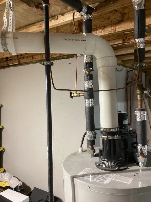 Provided estimate for replacement of existing Bradford White 65-gallon natural gas water heater, model M11TW65TGBN15 with 65,000 BTU/hr input rating. Documented current installation including recirculation pump assembly, black iron gas piping, and venting configuration in basement utility area. Captured specifications and clearance requirements for proper equipment sizing and code-compliant replacement.