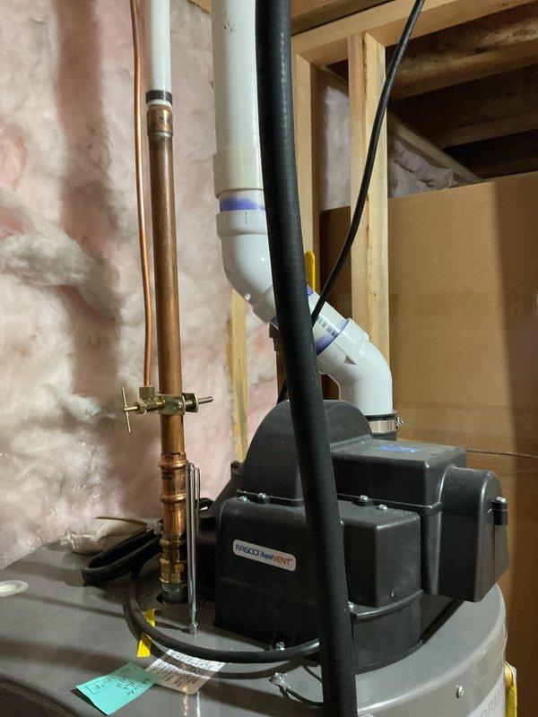 Responded to plumbing leak complaint involving water heater system. Upon inspection, identified active leak at water heater connections in basement utility area. Evaluated copper supply lines, PVC drainage piping, and vent system configuration. Inspected upper-level plumbing infrastructure including PVC drain lines and copper supply piping in attic space to assess extent of moisture intrusion and verify system integrity. Tightened connections at water heater inlet/outlet fittings and shutoff valve. Verified proper installation of temperature/pressure relief valve and discharge piping. Tested all connections under pressure to confirm leak elimination. System restored to normal operation with no further evidence of water discharge.