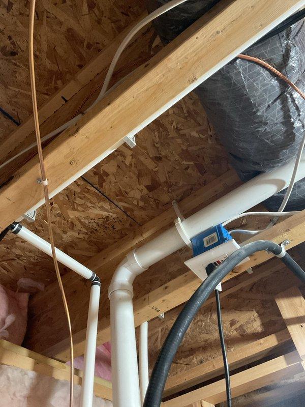 Responded to plumbing leak complaint involving water heater system. Upon inspection, identified active leak at water heater connections in basement utility area. Evaluated copper supply lines, PVC drainage piping, and vent system configuration. Inspected upper-level plumbing infrastructure including PVC drain lines and copper supply piping in attic space to assess extent of moisture intrusion and verify system integrity. Tightened connections at water heater inlet/outlet fittings and shutoff valve. Verified proper installation of temperature/pressure relief valve and discharge piping. Tested all connections under pressure to confirm leak elimination. System restored to normal operation with no further evidence of water discharge.