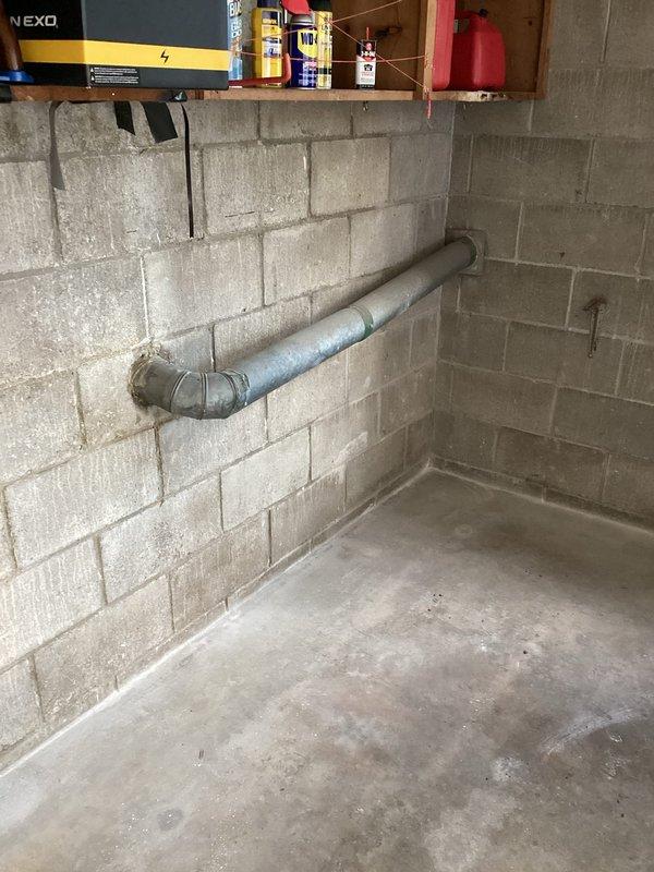 Responded to service call for dryer vent repair in basement utility area. Upon inspection, assessed existing ventilation system and mounting hardware along concrete block wall. Installed chrome mounting bar with copper-colored brackets to secure and support proper dryer vent routing, ensuring adequate clearance from stored materials and maintaining code-compliant installation standards for safe appliance operation.