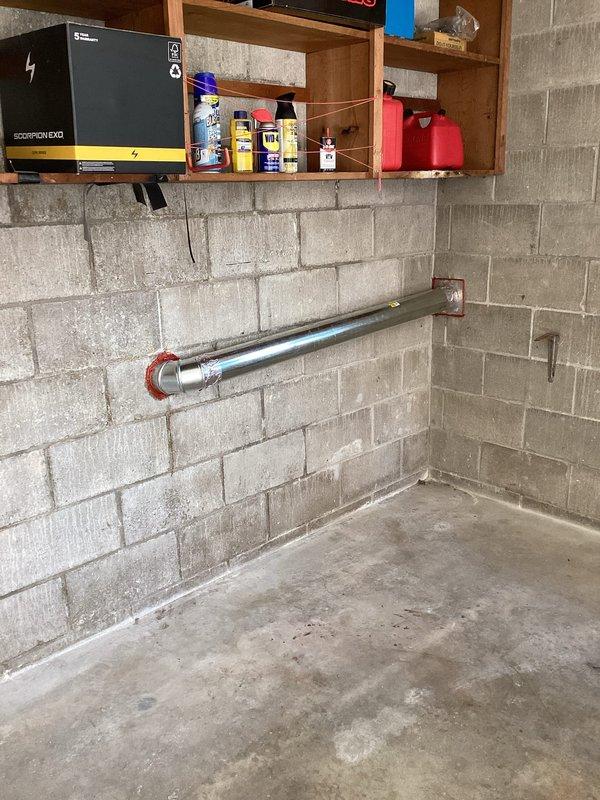 Responded to service call for dryer vent repair in basement utility area. Upon inspection, assessed existing ventilation system and mounting hardware along concrete block wall. Installed chrome mounting bar with copper-colored brackets to secure and support proper dryer vent routing, ensuring adequate clearance from stored materials and maintaining code-compliant installation standards for safe appliance operation.