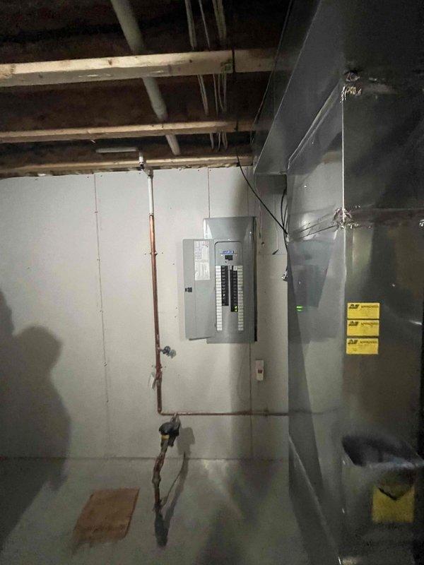 Conducted on-site evaluation for standby generator installation at residential property. Assessed existing electrical infrastructure including main service panel, meter location, and available utility space in basement mechanical room. Documented current electrical service configuration with digital meter and main distribution panel. Evaluated potential generator placement options and determined routing requirements for electrical connections, gas supply lines, and transfer switch installation. Photographed electrical service entrance equipment and basement utility area to support equipment sizing and installation planning for whole-house backup power system.