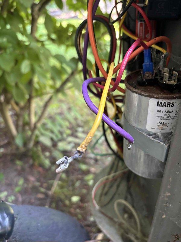 # Annual Cooling Maintenance Visit

Performed comprehensive annual cooling system maintenance on a 2022 unit. Upon inspection, discovered severely burnt wire insulation and carbonized electrical components indicating thermal failure at the capacitor connections. Found MARS dual-run capacitor (60+7.5µF) with corroded terminals and degraded wire connections, including damaged yellow wire with exposed copper conductor. Replaced failed capacitor and all compromised wiring to restore safe electrical connections. Cleaned and secured all terminal connections with proper spade connectors. Verified proper capacitance values and voltage readings post-repair. Completed standard tune-up procedures including coil cleaning, refrigerant charge verification, and operational testing. System restored to safe, efficient operation with all electrical hazards eliminated.