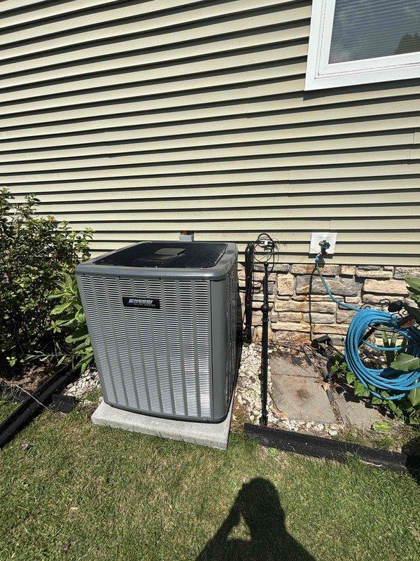 Completed full air conditioning system installation at residential property. Installed new outdoor condensing unit on concrete pad against exterior wall, ensuring proper clearance from structure and landscaping. Unit positioned with adequate airflow access and secured to manufacturer specifications. Connected refrigerant lines, verified proper evacuation and charging procedures using manifold gauge set, and confirmed system pressures within operating parameters. Tested all electrical connections, startup sequence, and overall system performance to ensure optimal cooling operation.