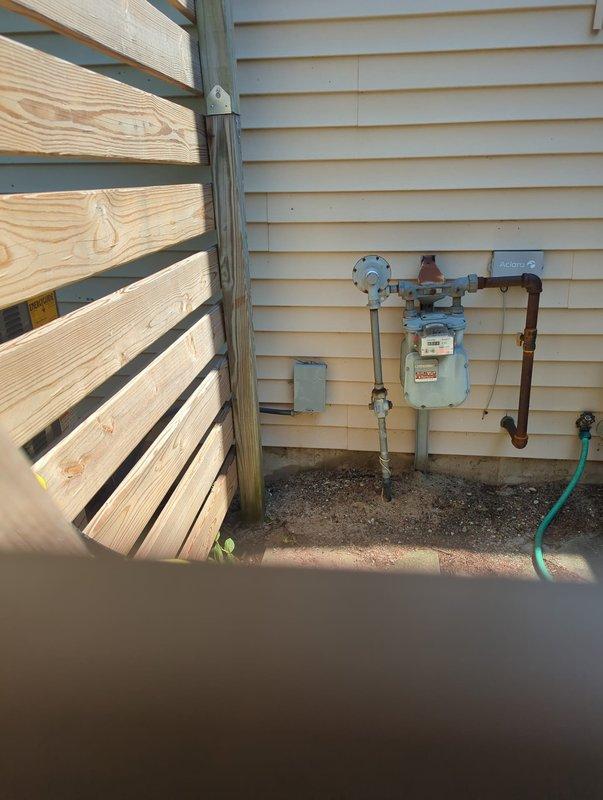 Completed full installation of new furnace and air conditioning system. Equipment installed in basement utility area with proper venting through vertical flue pipe extending floor to ceiling. All ductwork, refrigerant lines, and electrical connections completed to manufacturer specifications. Gas meter connections verified at exterior location with copper piping properly routed along building exterior. System tested and operational upon completion. Payment collected on site.