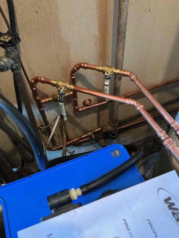 Completed installation of customer-provided water softener system in mechanical room, integrating unit into existing copper plumbing infrastructure with new bypass valves for proper flow control and maintenance accessibility. Configured all connections to water heater and main supply lines, tested system operation, and verified proper functionality upon completion.