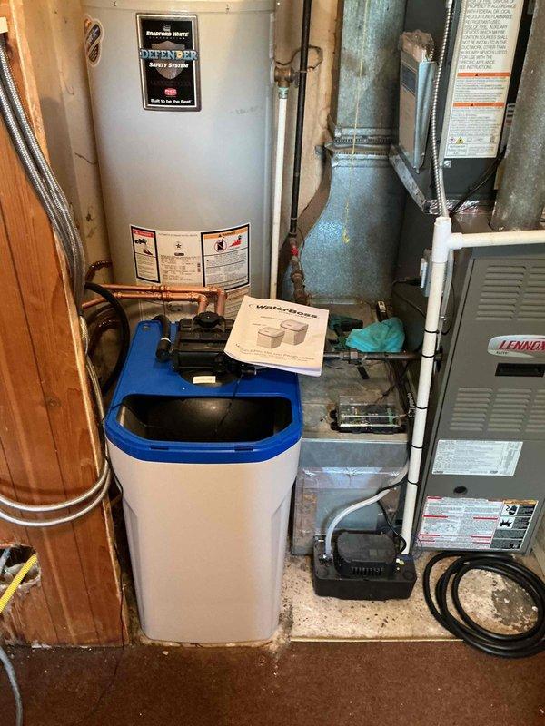 Completed installation of customer-provided water softener system in mechanical room, integrating unit into existing copper plumbing infrastructure with new bypass valves for proper flow control and maintenance accessibility. Configured all connections to water heater and main supply lines, tested system operation, and verified proper functionality upon completion.