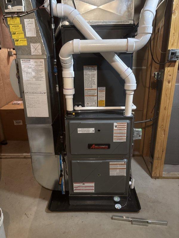 Completed full system replacement of residential furnace and air conditioning unit. Installed new Amana furnace in basement utility area with proper PVC venting configuration and mounted on code-compliant platform. Installed new outdoor condenser unit on concrete pad in side yard with proper electrical disconnect, refrigerant line routing, and secure positioning against exterior walls.