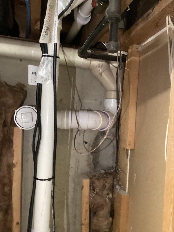 Conducted site assessment of existing plumbing infrastructure in basement area to provide estimate for smart water shut-off valve installation and backwater valve system. Inspected main water line configuration, existing meter assembly with brass fittings, and drainage system including multiple PVC pipes and connections. Documented current plumbing layout, pipe routing through floor joists, and identified optimal installation locations for requested equipment upgrades to protect property from potential water damage and sewer backup.