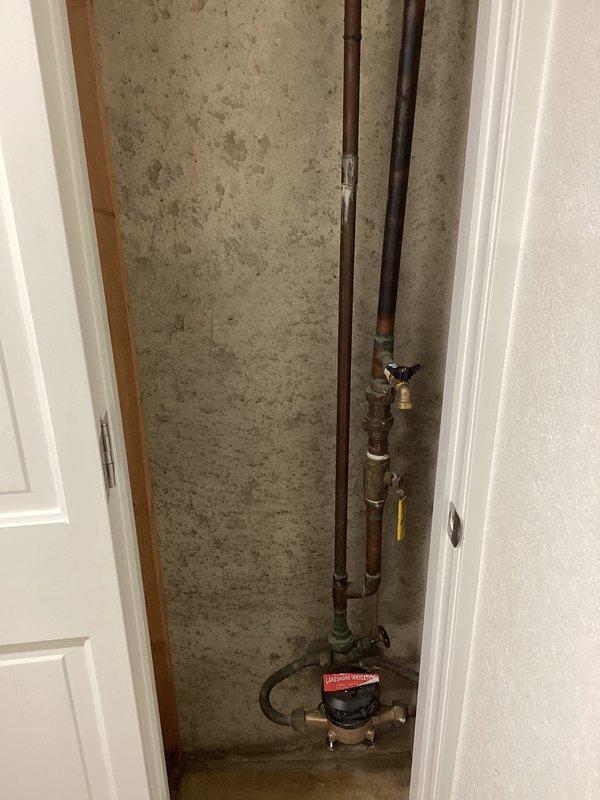 Conducted site assessment of existing plumbing infrastructure in basement area to provide estimate for smart water shut-off valve installation and backwater valve system. Inspected main water line configuration, existing meter assembly with brass fittings, and drainage system including multiple PVC pipes and connections. Documented current plumbing layout, pipe routing through floor joists, and identified optimal installation locations for requested equipment upgrades to protect property from potential water damage and sewer backup.