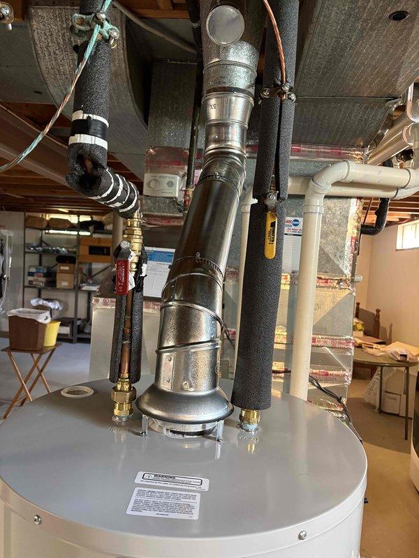 Completed installation of 40-gallon natural gas short water heater in basement utility area. Removed existing unit and installed new water heater with proper venting through flue assembly, connected supply and discharge lines using copper piping with brass fittings and valves, and ensured all connections were secure and code-compliant. System tested and verified operational upon completion.