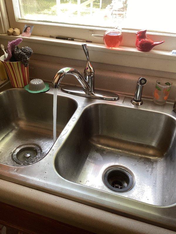 Responded to service call for leaking cold water valve at kitchen sink in 60+ year old residence. Upon inspection, identified failed valve seat and worn washer causing continuous drip from cold water supply line. Accessed shutoff valves in basement mechanical room, isolated water supply to affected fixture, and disassembled faucet assembly. Replaced deteriorated components including valve seat, washer, and O-rings. Restored water supply, tested operation under full pressure, and confirmed leak was fully resolved with no additional drips or seepage detected at sink or supply connections.