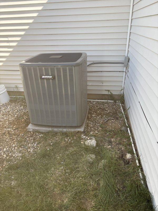 Completed full HVAC system replacement including new furnace installation in basement utility area and outdoor condensing unit. Furnace positioned with proper ductwork connections, including rigid metal supply ducts and insulated flexible return ductwork, with all electrical wiring properly routed through unfinished space. Exterior condensing unit set on concrete pad with refrigerant lines insulated and secured to building exterior, system charged and tested for proper operation.