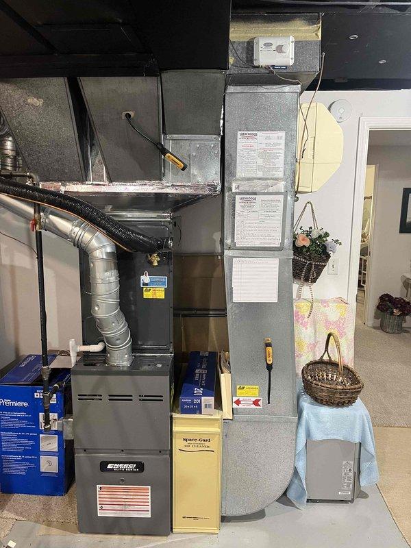 Completed annual cooling maintenance on residential HVAC system including inspection of furnace, air handler, and thermostat operation. Verified Honeywell programmable thermostat functioning properly with system in cooling mode at 75° setpoint, confirmed proper airflow through ductwork and filter accessibility, and documented equipment condition with photos showing all components operating within normal parameters.