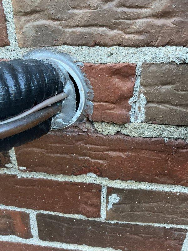 Responded to customer concern regarding loose caulking around HVAC penetration that was disturbed during recent maintenance visit. Inspected exterior wall penetration where refrigerant lines and condensate drain pass through brick exterior. Re-sealed penetration point with appropriate caulking material around metal flange and conduit entry to restore weather barrier and prevent pest intrusion into structure.