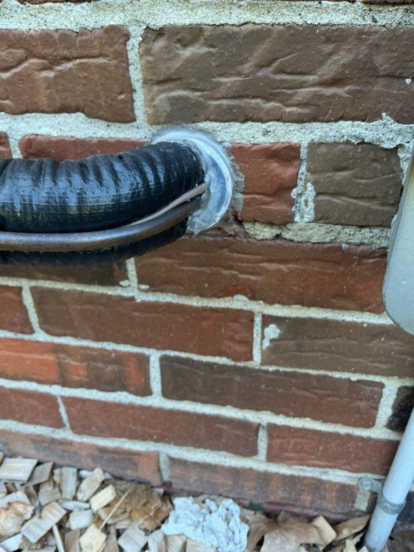 Responded to customer concern regarding loose caulking around HVAC penetration that was disturbed during recent maintenance visit. Inspected exterior wall penetration where refrigerant lines and condensate drain pass through brick exterior. Re-sealed penetration point with appropriate caulking material around metal flange and conduit entry to restore weather barrier and prevent pest intrusion into structure.