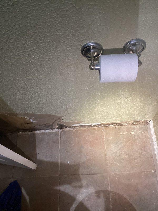 Responded to report of ceiling crack with mold growth initially suspected to be foundation-related. Upon inspection, identified active water staining on textured ceiling with brownish discoloration indicating moisture intrusion from plumbing system above. Documented conditions including water damage patterns on ceiling surface and secondary moisture indicators on bathroom floor tiles showing discoloration and staining. Confirmed plumbing leak as source of ceiling damage rather than structural foundation issue. Photographed affected areas for documentation and recommended follow-up plumbing repairs to address leak source and subsequent mold remediation of damaged ceiling materials.