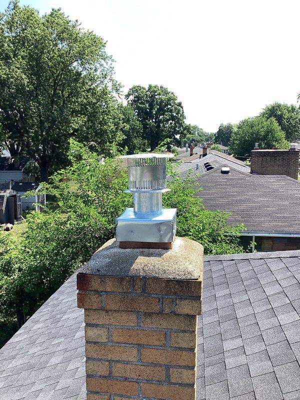 Installed a 50-gallon natural gas water heater with 10-year tank and 10-year parts warranty in basement utility room. Ran new copper supply lines, connected gas line, and installed chimney liner system with new galvanized flue cap assembly on existing brick chimney to ensure proper venting and code compliance.