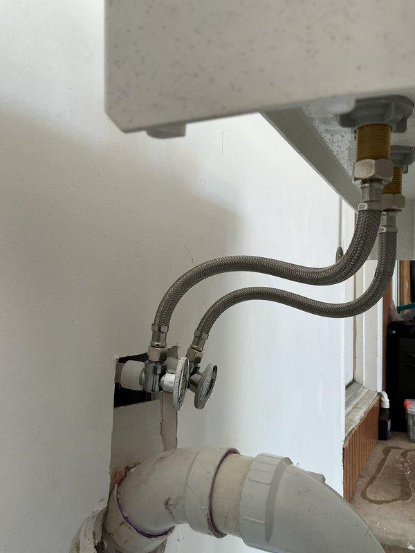Completed installation of new laundry sink with chrome faucet and replaced three frost-free exterior spigots. The utility sink was mounted on metal legs with proper supply line connections using braided stainless steel hoses and chrome shut-off valves, along with PVC drain piping installed to code.