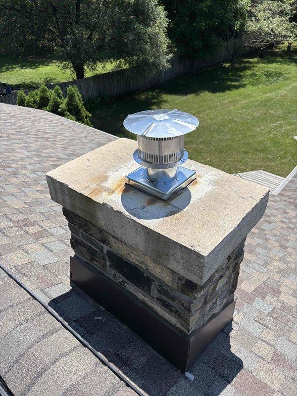 Completed full installation of residential HVAC system including new furnace and air conditioning unit. Installed Carrier brand outdoor condensing unit on concrete pad with proper clearance from structure, connected refrigerant lines and electrical conduit to exterior wall penetration. Secured all line sets and wiring along vinyl siding per manufacturer specifications. Verified proper positioning and leveling of outdoor unit on existing concrete pad. Confirmed chimney chase cover and rain cap are properly secured on masonry chimney structure with appropriate flashing at roof penetration. All components installed to code with system ready for operation.