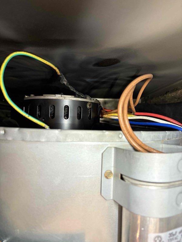 Responded to service call for air conditioning unit not working with burning smell reported. Upon arrival, coordinated with customer per their request for advance notice. Inspected HVAC system and discovered significant water accumulation beneath unit with visible moisture staining on floor surface, indicating drainage issue or condensate leak. Examined electrical components and wiring connections within unit, identifying potential source of burning odor near control board and motor assembly. Documented conditions with photos showing water damage patterns and internal electrical components for service records.