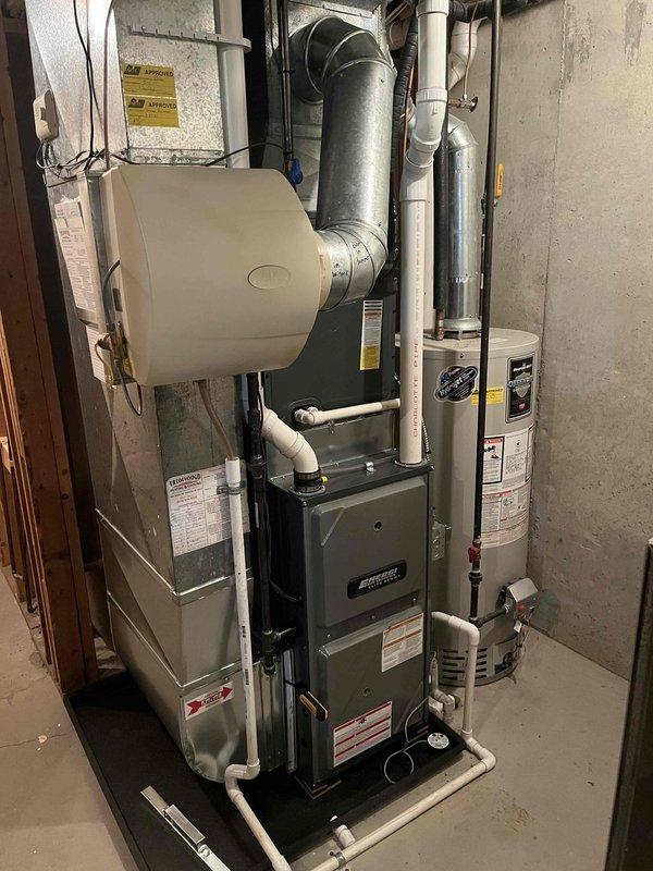 Completed annual cooling maintenance on residential HVAC system. Performed comprehensive inspection of furnace and air conditioning equipment located in basement mechanical room. Verified proper operation of Emerson programmable thermostat, which was holding at 77 degrees in cooling mode and displaying accurate room temperature. Inspected all PVC drainage and venting lines connected to furnace unit for proper installation and flow. Examined ductwork connections including humidifier unit mounted to supply plenum. Checked electrical connections and wiring at equipment and panel. System operating within normal parameters with no deficiencies noted at time of service.