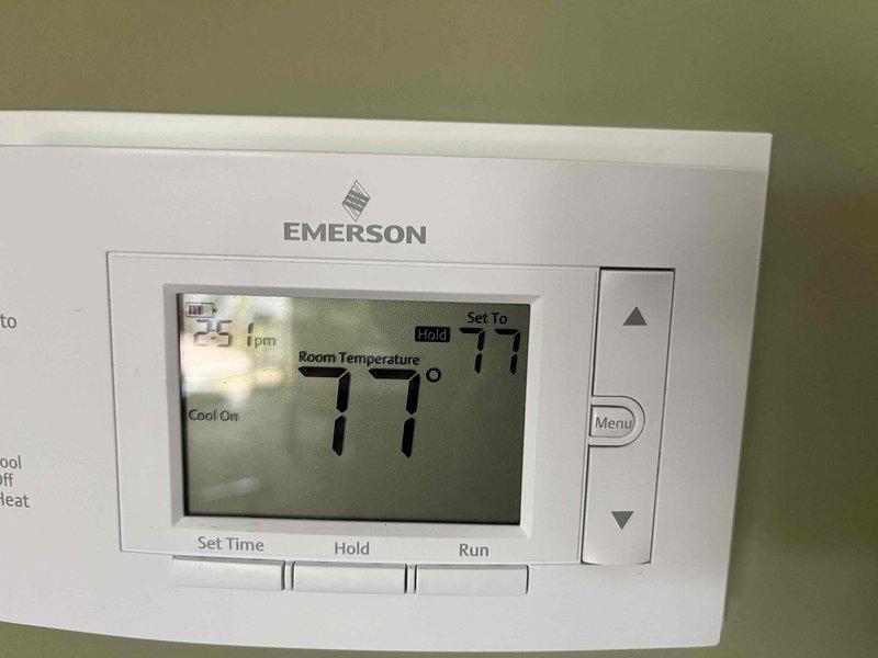 Completed annual cooling maintenance on residential HVAC system. Performed comprehensive inspection of furnace and air conditioning equipment located in basement mechanical room. Verified proper operation of Emerson programmable thermostat, which was holding at 77 degrees in cooling mode and displaying accurate room temperature. Inspected all PVC drainage and venting lines connected to furnace unit for proper installation and flow. Examined ductwork connections including humidifier unit mounted to supply plenum. Checked electrical connections and wiring at equipment and panel. System operating within normal parameters with no deficiencies noted at time of service.