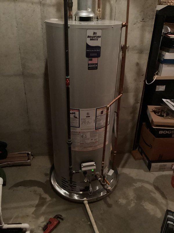 Responded to water leak complaint on 3-year-old Bradford White 50-gallon natural gas water heater. Upon inspection, confirmed active leaking from bottom of tank, indicating internal tank failure. Documented unit specifications and condition with photos showing manufacturer labels, piping connections, and basement installation location. Customer was informed that tank leaks cannot be repaired and complete water heater replacement is required.