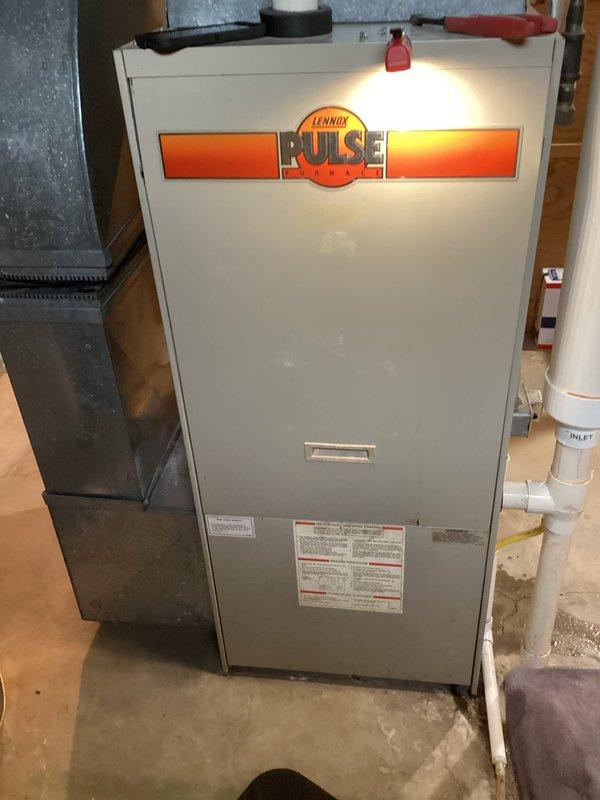 Responded to service call for air conditioning unit discharging water onto floor with suspected condensate drainage issue. Upon arrival, inspected Lennox Pulse furnace system and associated outdoor condensing unit. Examined condensate drain lines and PVC piping routing from indoor unit. Cleared blockage in condensate drain line that was causing water backup and overflow onto basement floor. Verified proper drainage flow and tested system operation to confirm issue resolved. Unit operating normally with condensate draining properly through designated drain lines.