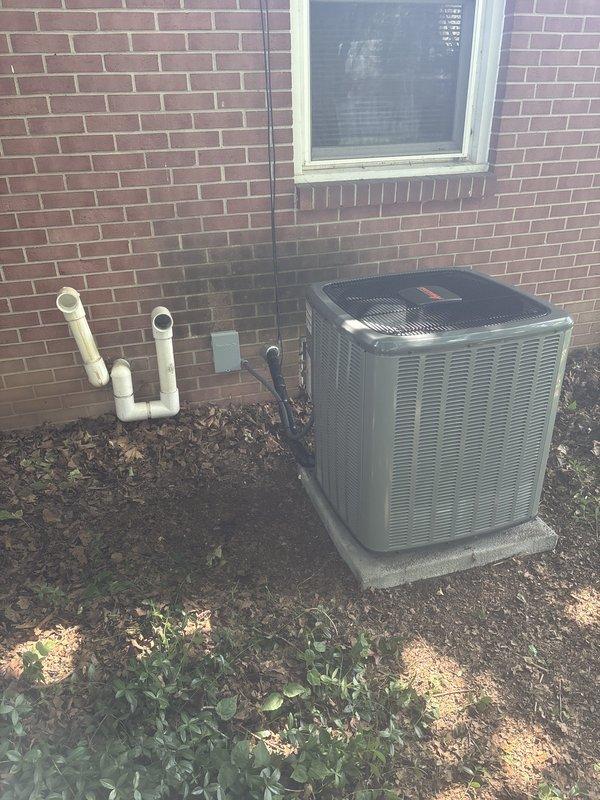 Completed full air conditioning system replacement including outdoor condensing unit and indoor air handler. Installed new York HVAC equipment with proper refrigerant lines, electrical connections, and condensate drainage. Mounted outdoor unit on existing concrete pad adjacent to building with appropriate clearances, connected electrical disconnect, and routed refrigerant lines through brick wall penetration. Indoor installation included air handler placement in basement mechanical area with integration to existing ductwork, PVC venting configuration, and proper electrical terminations. System was pressure tested, evacuated, charged to manufacturer specifications, and verified operational with all safety controls functioning correctly.