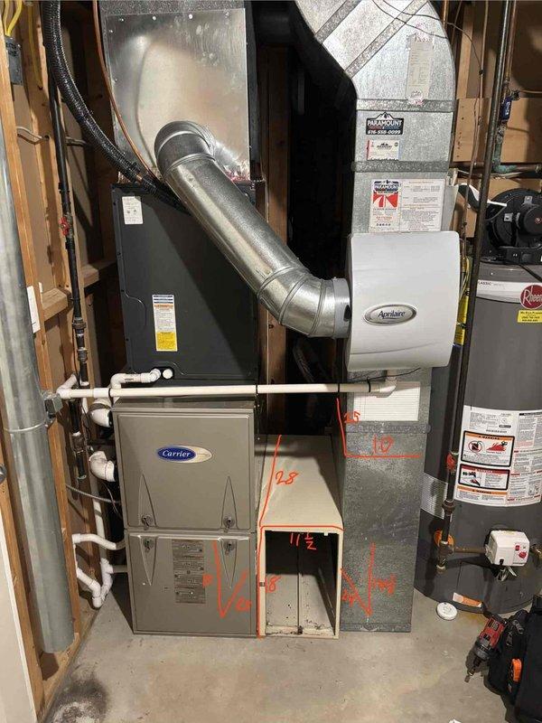 Conducted site assessment of basement HVAC system to evaluate electronic air filter removal. Documented existing Carrier furnace installation with connected ductwork, Aprilaire humidifier, and current air filtration configuration. Photographed equipment layout and measurements to provide accurate estimate for electronic air filter removal and any necessary ductwork modifications.