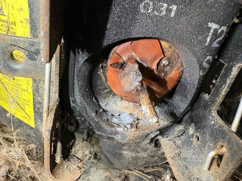 # AC Unit No Cool Service Call

Responded to service call for 12-year-old air conditioning unit that would not turn on. Upon arrival, performed complete system inspection to diagnose the no-cool condition. 

Visual inspection revealed extensive corrosion and deterioration throughout critical mechanical components. Found severely corroded shaft coupling and connecting elements showing advanced rust penetration with orange-brown discoloration and metal flaking. Observed heavy mineral buildup and crusty white deposits on multiple metal components, indicating prolonged moisture exposure. Equipment housing and mounting brackets displayed significant aging with accumulated dirt, debris, and environmental contamination.

Central mechanical junction point exhibited critical degradation with corroded circular coupling component showing deep surface cracking and material breakdown. Supporting metal pipes and tubes demonstrated reddish-brown rust coloration throughout. Equipment frame components 