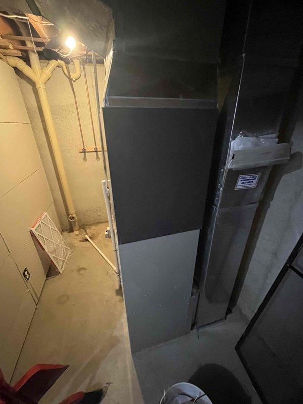 Completed full HVAC system replacement in residential basement utility area. Installed new furnace unit with properly configured ductwork connections, ensuring all metal duct joints were sealed and secured for optimal airflow. Work area was cleaned and all equipment positioned for proper clearance and serviceability.