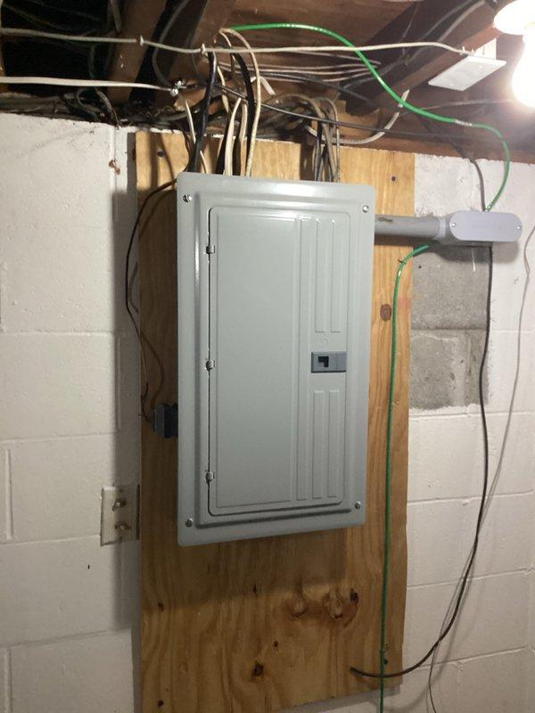 Conducted on-site evaluation for central air conditioning system installation in ranch-style home with no existing AC infrastructure. Assessed electrical service capacity and panel configuration to determine compatibility with new HVAC equipment requirements. Documented existing 200-amp electrical panel with available breaker slots and verified adequate power supply for proposed central air system installation, noting exposed basement utility area suitable for equipment placement and distribution routing.