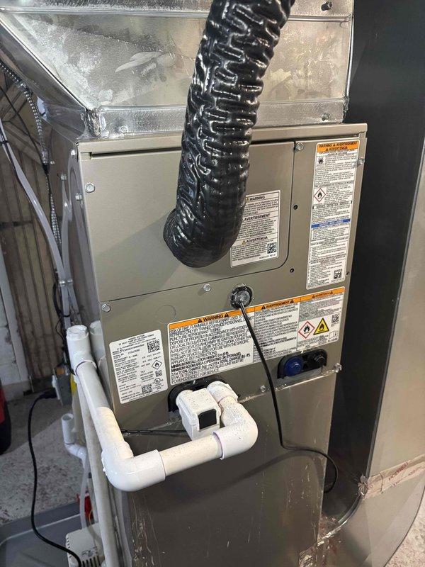 Responded to service call for newly installed air conditioning system with water pooling around unit on three sides and inadequate cooling performance. Inspected HVAC air handler installation, electrical connections, and condensate drainage system. Verified proper wiring configuration at junction box, examined PVC condensate drain line routing and trap assembly, and assessed overall system operation to identify source of water leakage and cooling deficiency.