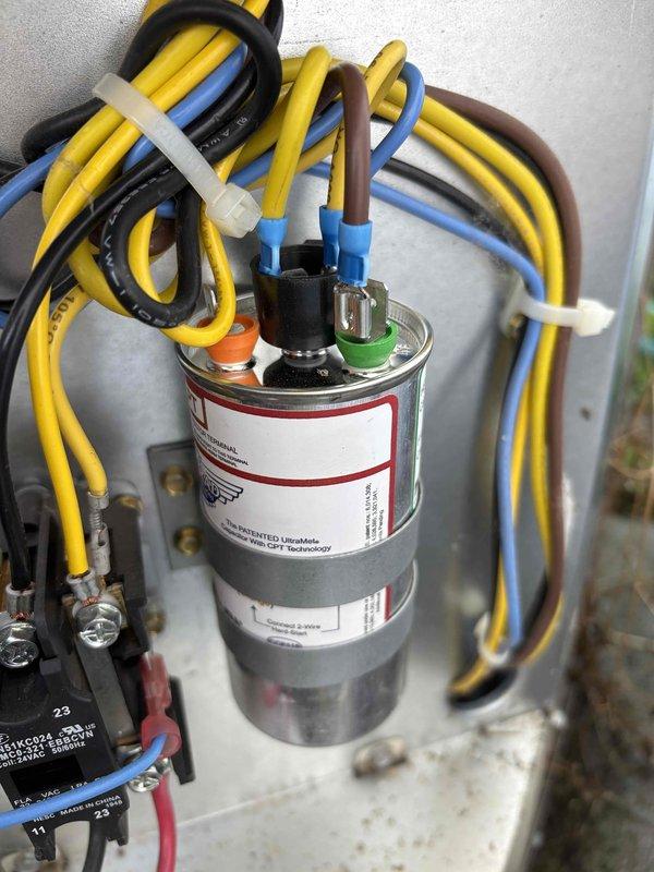 # NC-No Cool Service Completed

Responded to a no-cooling complaint on a 6-year-old Payne air conditioning system with a history of similar issues. Upon arrival, performed system diagnostics and found the outdoor unit was not operating. Inspection of the electrical components revealed a failed run capacitor preventing compressor and condenser fan motor operation.

Tested the capacitor with a multimeter and confirmed it was reading out of acceptable range specifications. Disconnected power to the unit and safely discharged the defective capacitor. Removed the failed component and installed a new OEM-equivalent run capacitor with proper microfarad rating for the system. Connected all electrical terminals according to manufacturer wiring diagram, ensuring proper color-coded wire placement to HERM, FAN, and COM terminals.

Verified all wire connections were secure and properly terminated. Restored power to the unit and initiated system startup. Confirmed compressor engaged properly and con