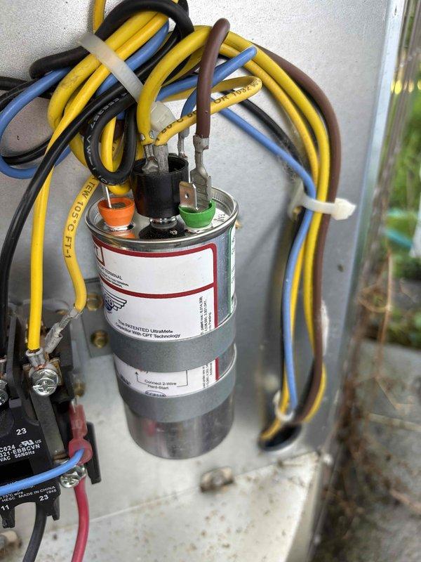 # NC-No Cool Service Completed

Responded to a no-cooling complaint on a 6-year-old Payne air conditioning system with a history of similar issues. Upon arrival, performed system diagnostics and found the outdoor unit was not operating. Inspection of the electrical components revealed a failed run capacitor preventing compressor and condenser fan motor operation.

Tested the capacitor with a multimeter and confirmed it was reading out of acceptable range specifications. Disconnected power to the unit and safely discharged the defective capacitor. Removed the failed component and installed a new OEM-equivalent run capacitor with proper microfarad rating for the system. Connected all electrical terminals according to manufacturer wiring diagram, ensuring proper color-coded wire placement to HERM, FAN, and COM terminals.

Verified all wire connections were secure and properly terminated. Restored power to the unit and initiated system startup. Confirmed compressor engaged properly and con