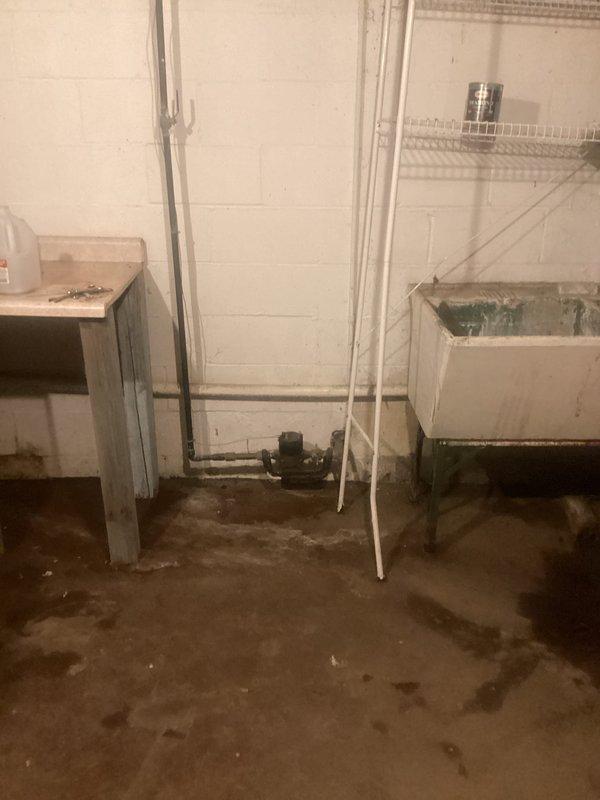 Installed 30,000 grain capacity water softener system in basement utility area with complete plumbing connections. System includes primary softener tank with digital control head, brine tank, and associated copper and PVC supply lines properly connected to existing water infrastructure. Installation completed per manufacturer specifications with all components operational and ready for service.