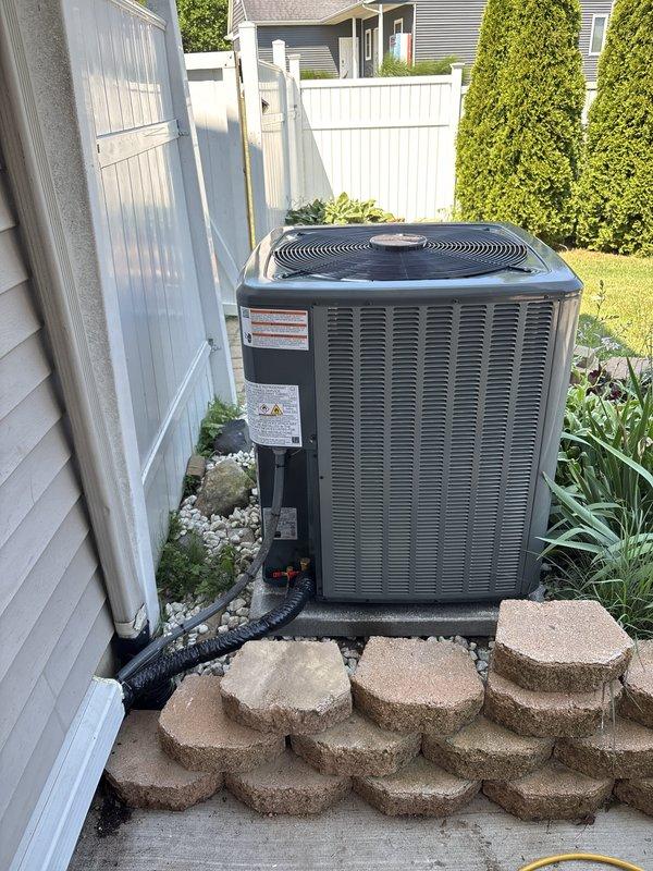 Completed full HVAC system replacement including outdoor condensing unit and indoor air handler. Installed new condenser on existing concrete pad in backyard with proper clearances from structure and fencing. Ran new refrigerant lines and electrical conduit connections between outdoor and indoor units. Mounted air handler in basement mechanical space with proper drainage piping and gas line connections. Verified all manufacturer specifications, completed electrical connections at junction box, and ensured proper labeling of all components. System tested and operational upon completion.