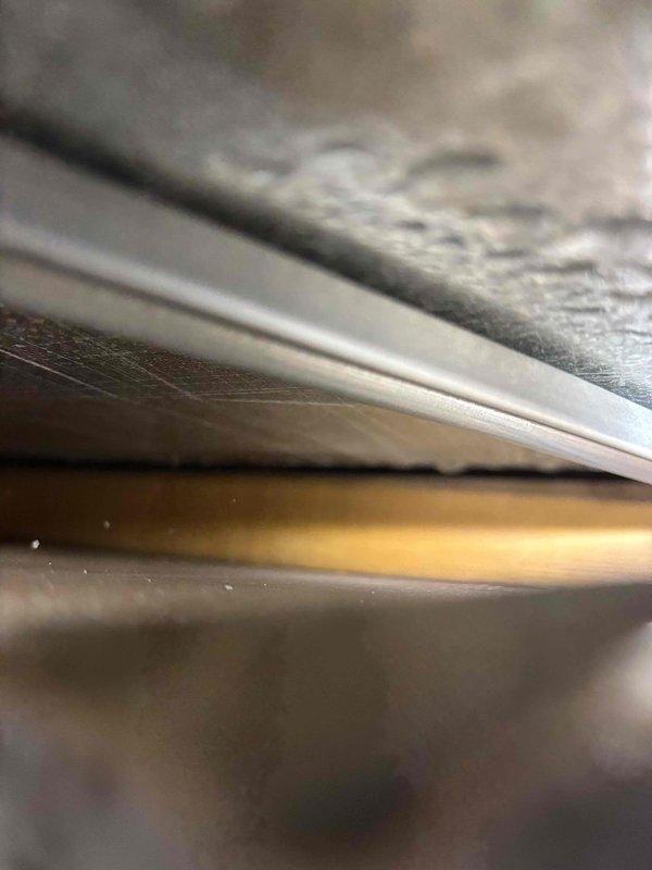Responded to water leak service call and performed diagnostic investigation. Opened wall to trace source of moisture infiltration. Upon inspection, determined leak was not originating from plumbing system but from HVAC equipment approximately 4 years old. Documented findings with photographs showing ceiling and wall water damage, as well as copper refrigerant line and sheet metal ductwork components. Advised customer to contact HVAC specialist for proper repair of air conditioning system.