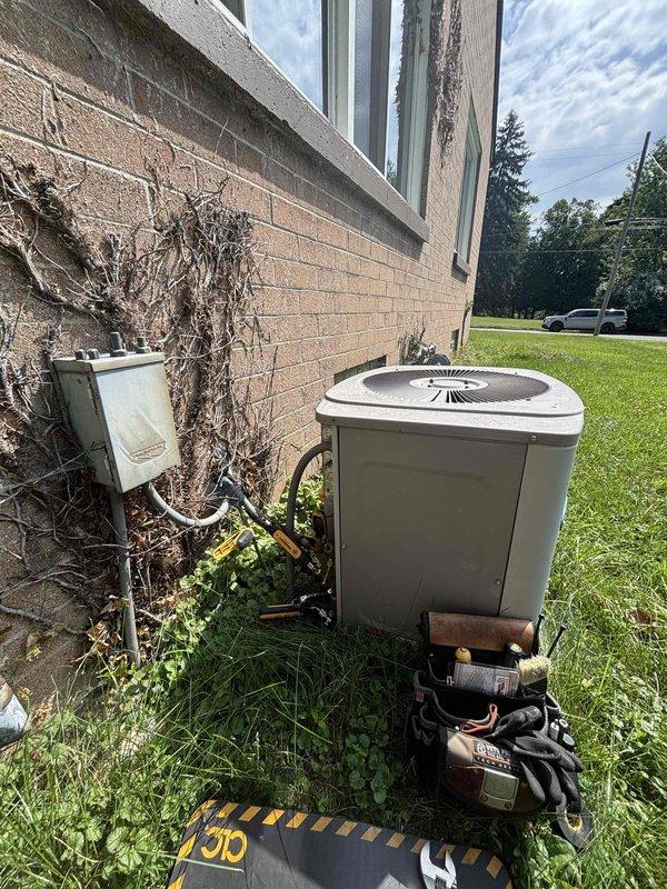 Responded to service call for air conditioning system not adequately cooling residence after extended period of non-use. Upon arrival, performed visual inspection of outdoor condenser unit and found extensive accumulation of dirt, debris, and organic matter coating the condenser coils and protective grille. The heavy buildup was significantly restricting airflow through the unit, reducing heat exchange efficiency and overall cooling capacity. Cleaned condenser coils and exterior surfaces to restore proper airflow and system performance. Verified electrical connections at disconnect box were secure and operational.
