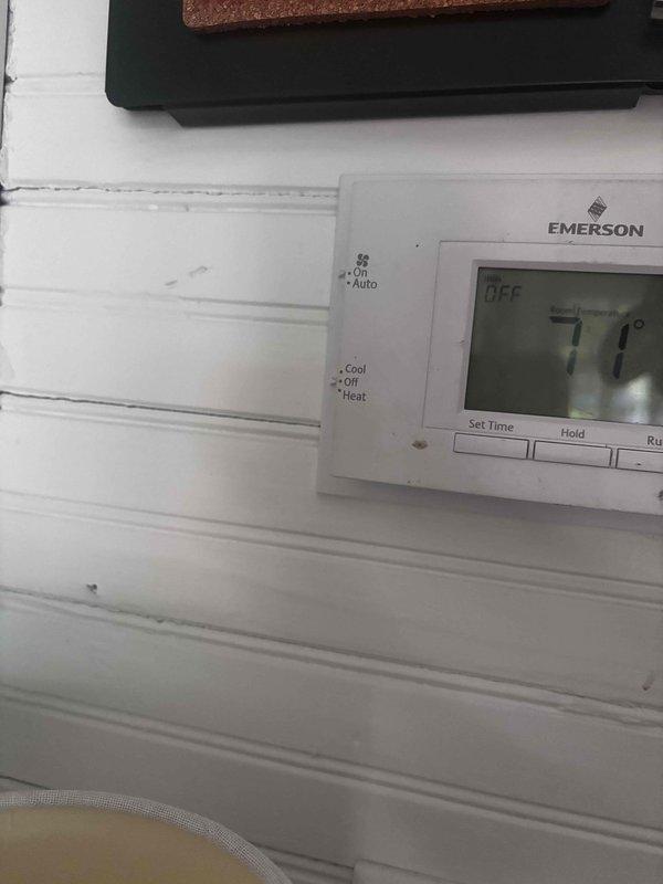 Responded to service call for reported thermostat issue with air conditioning system on 10-year-old Payne unit. Upon arrival, inspected Emerson digital thermostat mounted on exterior wall and examined zone control panel with damper and sensor connections. Verified thermostat display functionality, checked wiring connections at both thermostat and zone control terminal blocks, and confirmed proper voltage at R and C terminals. System demonstrated ability to cool as reported by customer. Photographed thermostat interface and zone control wiring configuration for documentation. All connections secure, no immediate faults identified during inspection.